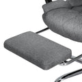 Close-up of grey fabric retractable footrest pad with chrome support arm from executive office chair on white background