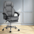 Grey fabric high-back executive chair with retractable footrest and chrome base in grey-panelled lifestyle room