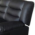 Close-up of black leather recliner sofa backrest showing quilted tufted cushion panels