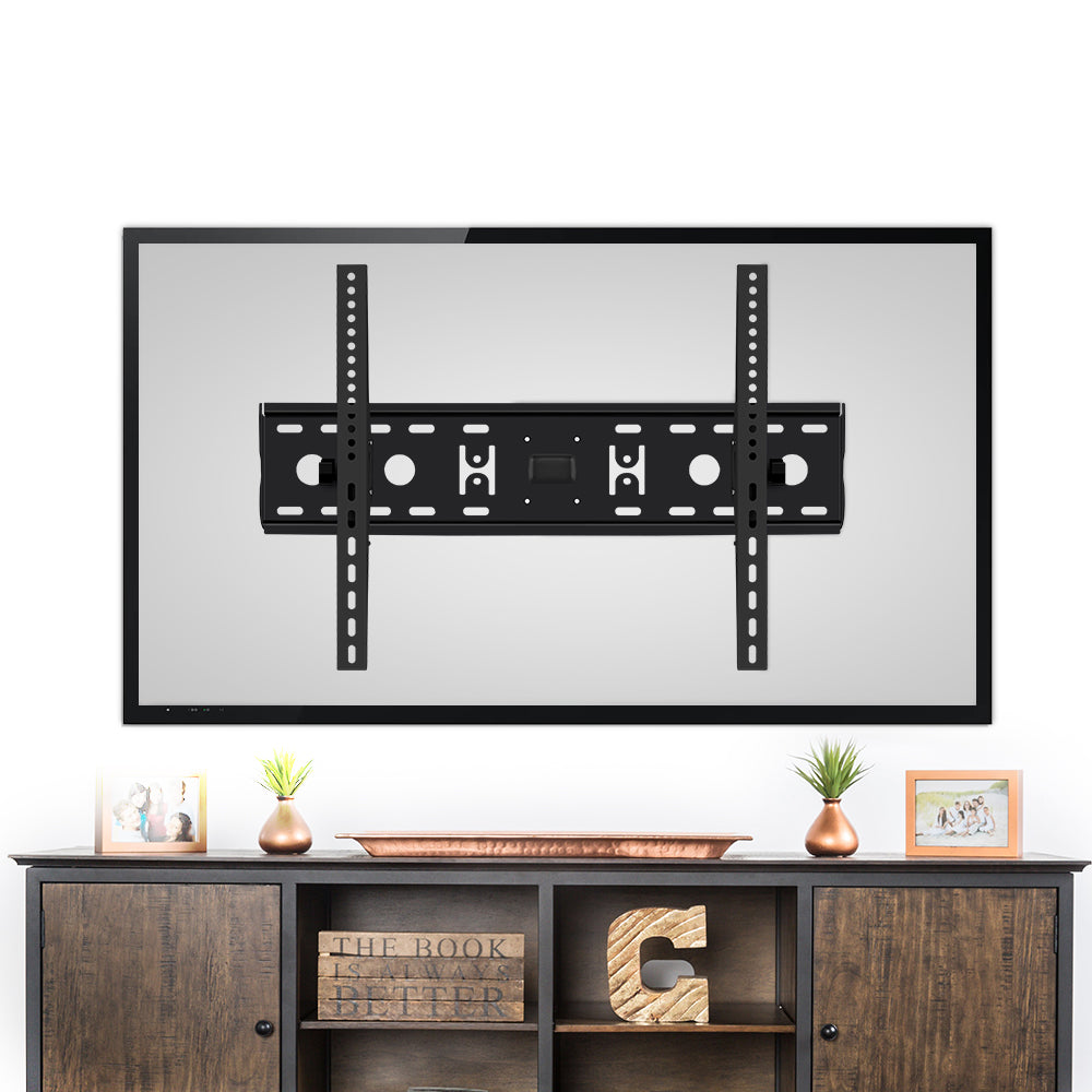 Fixed TV wall bracket shown on back of large TV above dark wood TV unit with copper vases photo frames and ornament