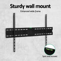 Black wide fixed TV wall bracket on grey concrete wall sturdy wide frame with spirit level included callout circle