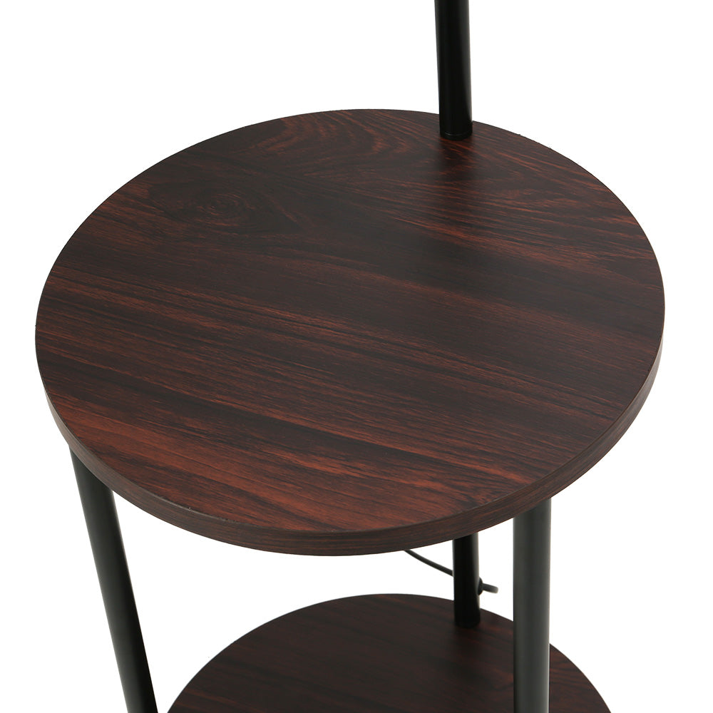 Close-up angled view of round dark walnut upper shelf on black metal poles with lower shelf visible below