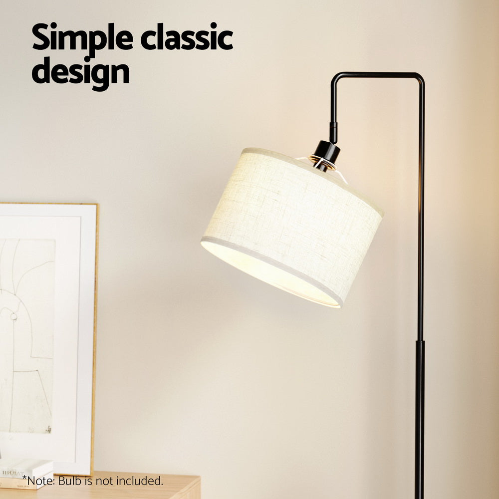 Arc floor lamp head with illuminated cream linen shade and black curved arm in room, text reads Simple classic design