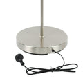 Close-up of round brushed nickel base of dual-shade floor lamp with black power cord and AU plug on white background