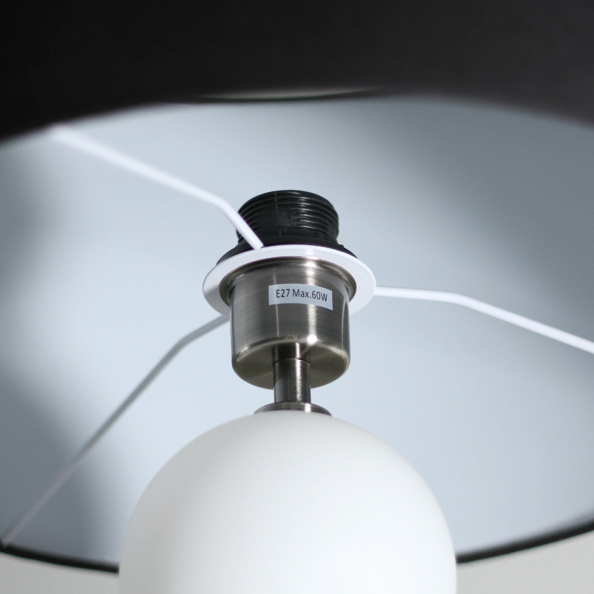 Underside view of dark grey drum shade, white interior lining, chrome E27 Max.60W socket, white cord and glass ball below