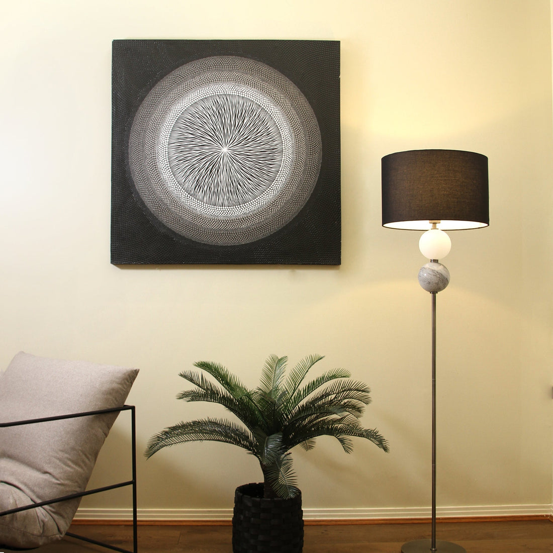 Floor lamp with dark grey drum shade, white frosted and black crackled glass balls on chrome rod, round chrome base, white bg