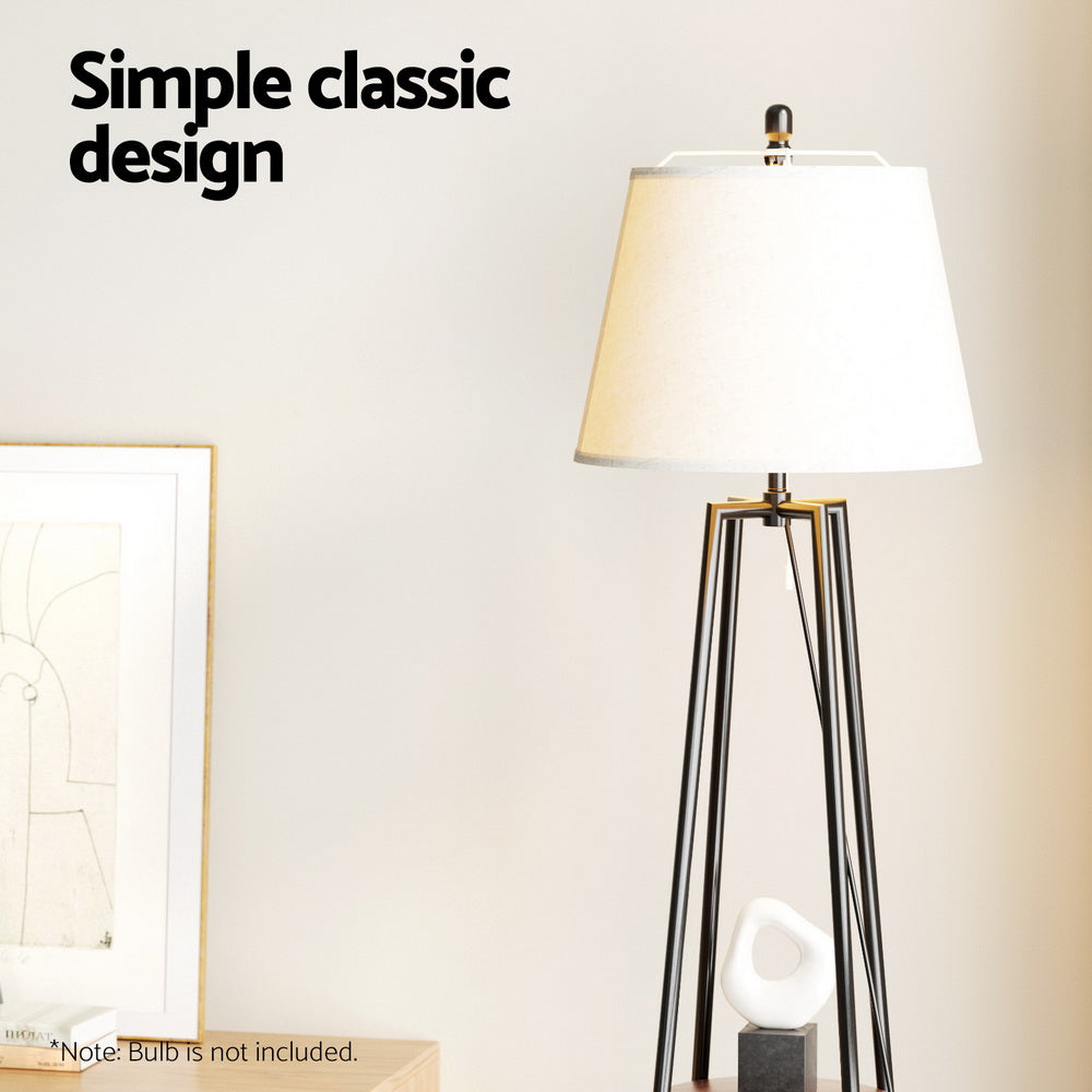 Tripod floor lamp with white fabric shade and black metal four-leg base in room, text reads Simple classic design