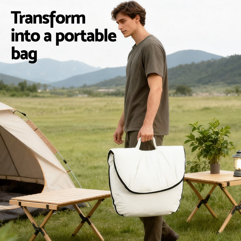 Man carrying folded white floor chair as a portable bag at campsite, text reads "Transform into a portable bag"