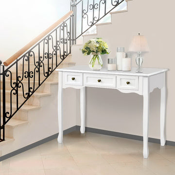 White French provincial console table with three drawers and curved cabriole legs, styled in staircase entryway