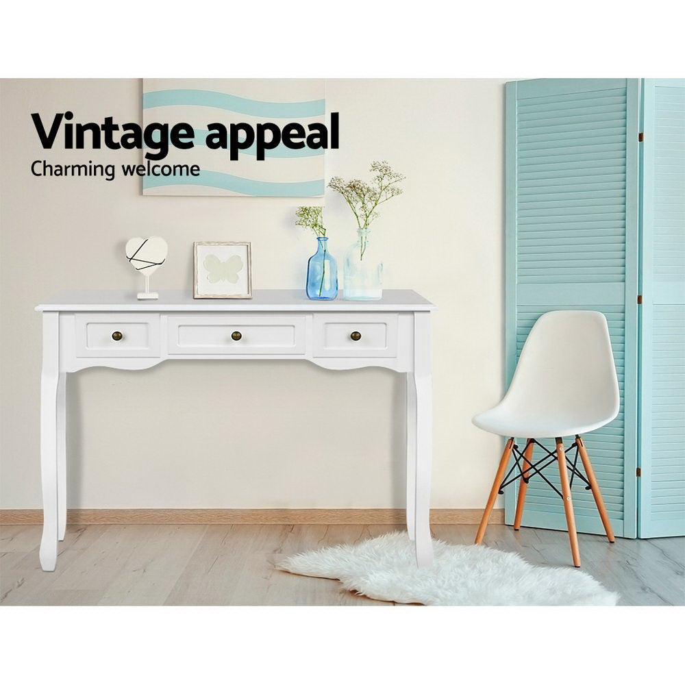 White French provincial console in room with blue vases and vanity mirror; Eames chair beside; text "Vintage appeal"