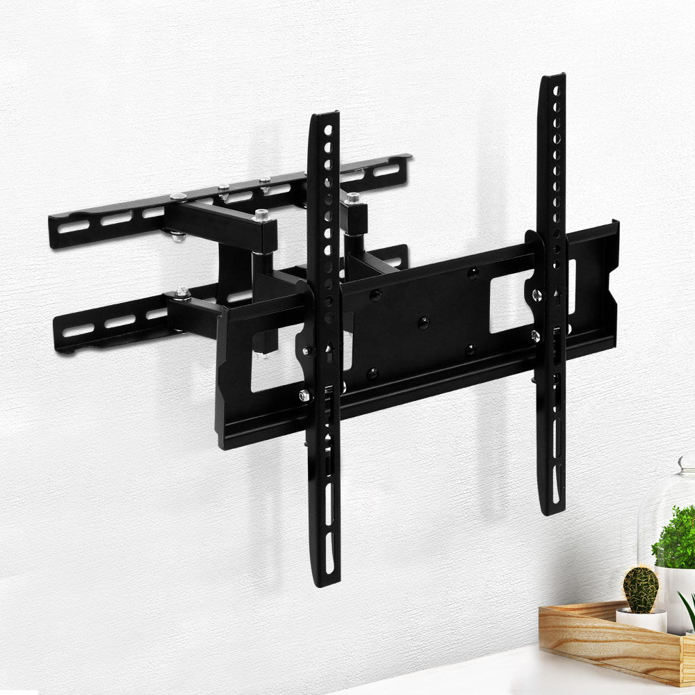 Full-motion TV wall bracket extended arms on white textured wall lifestyle with cactus and plant on wood tray