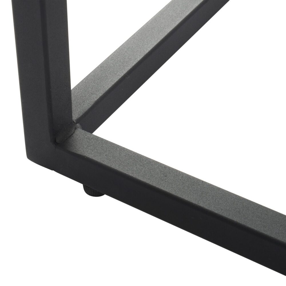 Close-up detail of black powder-coated metal table foot and frame junction with small rubber floor protector pad on white