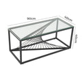 Rectangular clear glass-top coffee table with black metal starburst base: 90cm length, 40cm width and 40cm height annotations