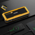 GOOLOO GP4000 Pro Titan jump starter charging a phone via USB on dark surface; inset showing USB and Type-C ports