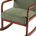 Close-up of green corduroy rocking chair seat and armrests showing ribbed fabric texture and curved dark wood rocker base