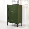 Dark green metal two-compartment stacked locker cabinet with art print on top beside floor lamp, angle view in room