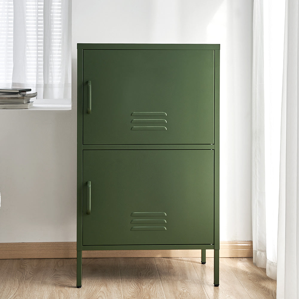 Dark green metal two-compartment locker cabinet with stacked doors and vent slots in lifestyle room setting