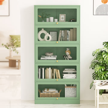 Sage green 5-door barrister display cabinet in room, books and decor visible through mesh doors, gold knobs, monstera beside