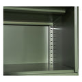 Close-up interior of green metal locker cabinet showing two shelves and perforated side track for height adjustment