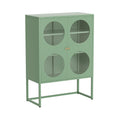 Green metal display cabinet with four circular glass windows, gold knobs and open metal base frame, three-quarter angle view