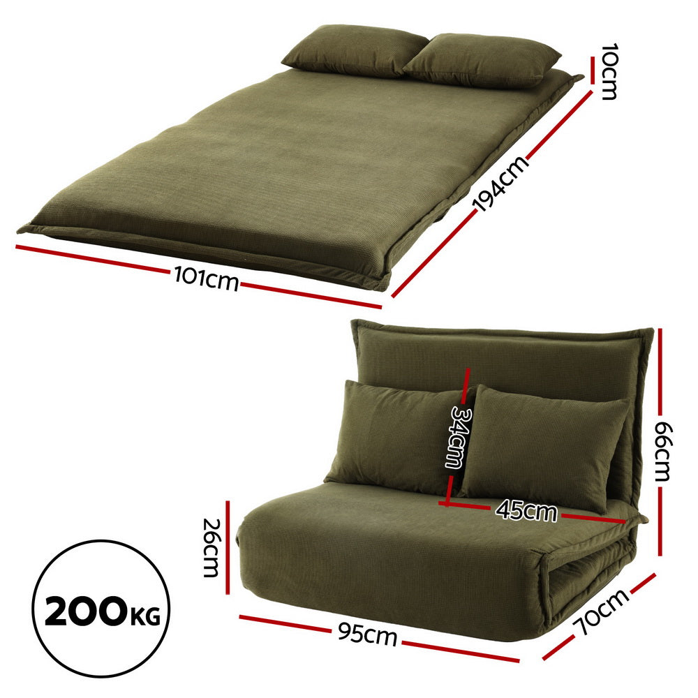 Green velvet 2-seater floor sofa bed three-quarter angle view in sofa mode showing cushion depth on white background