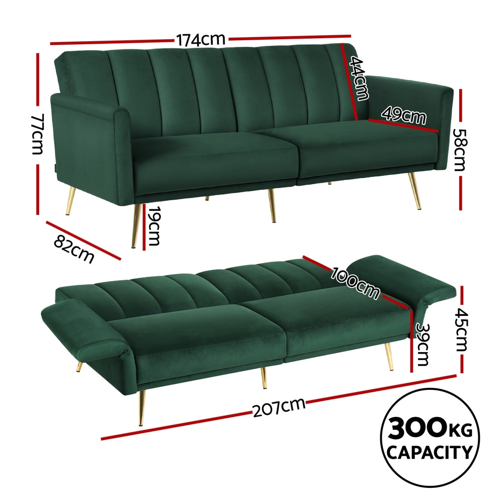 Dark green velvet sofa bed with vertical channel stitching on backrest and gold metal legs on white background