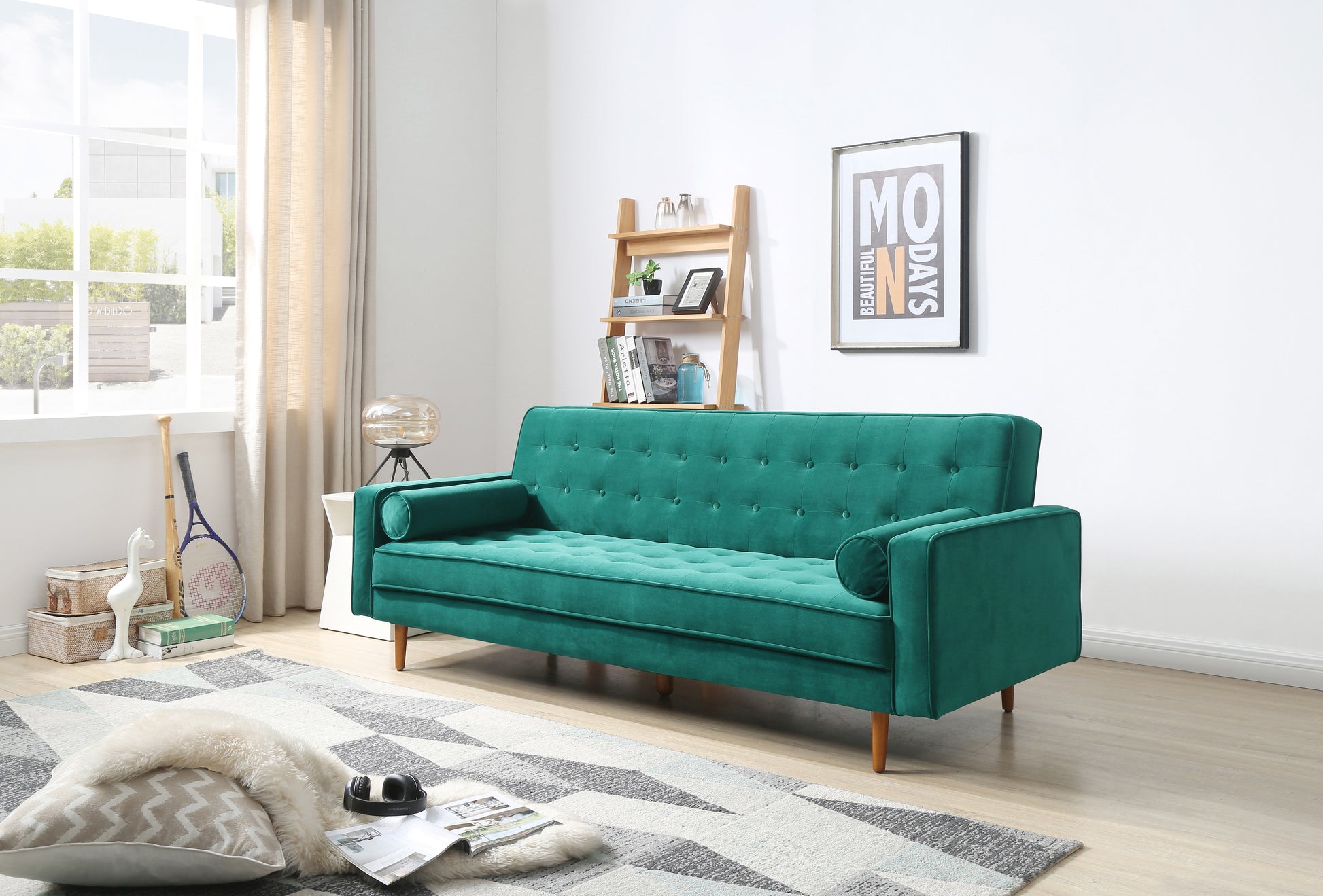 Green velvet tufted sofa bed in living room with wooden ladder shelf and artwork on wall