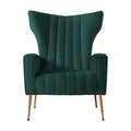 Dark green velvet wingback armchair with vertical channel tufting, flared wings, and gold metal tapered legs, front view