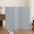 Grey 3-panel room divider zigzag configuration in living room lifestyle with open book on floor and vase on sideboard