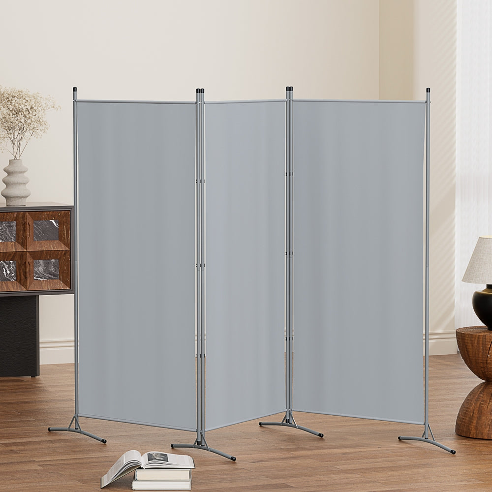 Grey 3-panel room divider zigzag configuration in living room lifestyle with open book on floor and vase on sideboard