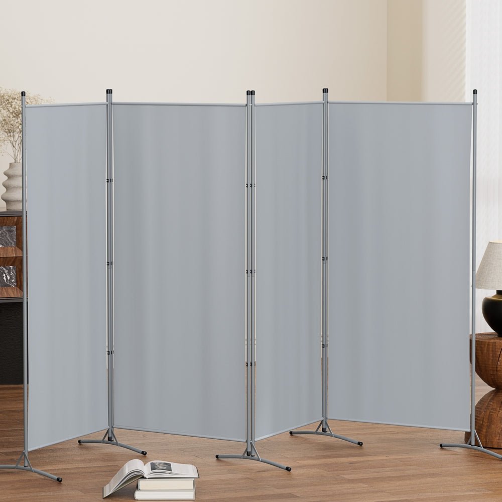 Grey 4-panel room divider zigzag configuration in living room lifestyle with open book on floor lamp and vase on sides