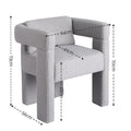 Grey boucle armchair with thick column legs, open back slot and flat wraparound arms, angle view on white background