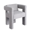 Grey boucle armchair in lifestyle setting, 150KG capacity badge, 16cm seat depth, text: Boucle fabric upholstery