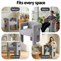 Grey boucle armchair with open back, column legs and removable cushion visible, front-right angle view on white background