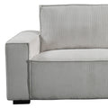 Close-up of light grey corduroy sofa arm corner showing ribbed vertical texture and small black leg