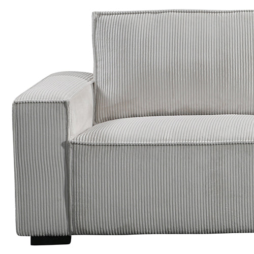 Close-up of light grey corduroy sofa arm corner showing ribbed vertical texture and small black leg