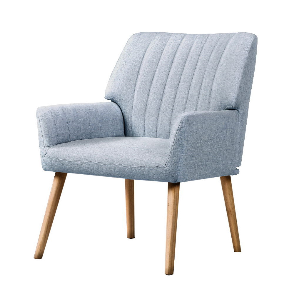 Light grey fabric accent chair with vertical channel stitching and tapered wood legs angle view on white background