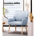 Light grey fabric accent chair in living room lifestyle shot with 150kg weight capacity badge overlay