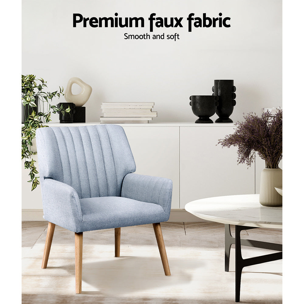 Light grey fabric accent chair in lounge room next to sideboard with Premium faux fabric text overlay