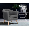 Grey fabric barrel chair on wooden legs in dark room, badges: Premium fabric, Wear-resistant, Breathable, Soft touch