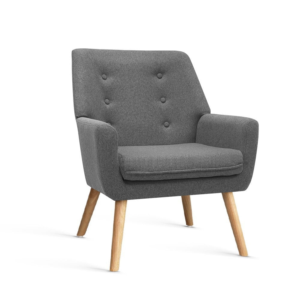 Grey fabric button-tufted armchair with wood splayed legs, five-button backrest, three-quarter view on white background