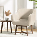 Grey fabric push-back recliner with adjustable headrest and footrest extended, beside glass vase with branch, bright room