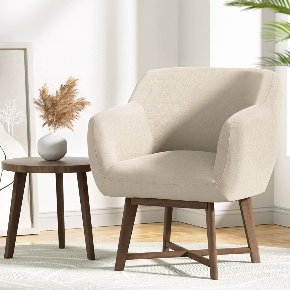 Grey fabric push-back recliner with adjustable headrest and footrest extended, beside glass vase with branch, bright room
