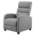 Grey fabric recliner chair with segmented padded back, rounded arms and black bun feet, angle view on white background
