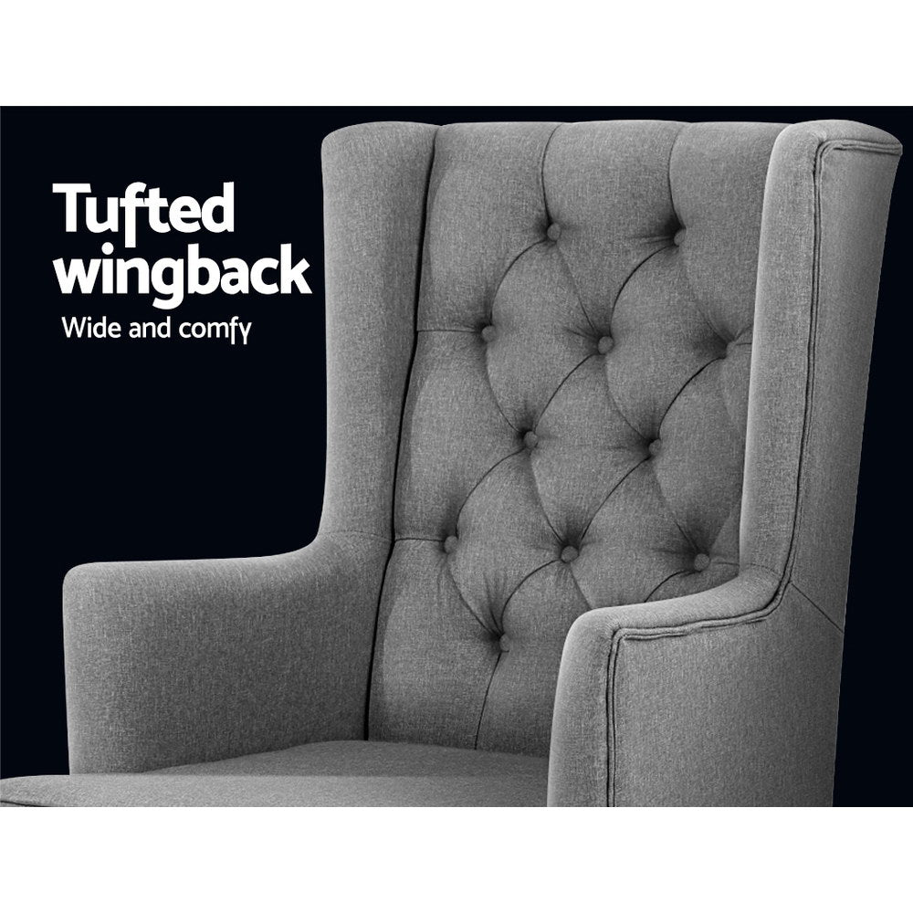 Grey fabric rocking chair close-up of diamond button-tufted wingback against dark background, Tufted wingback text