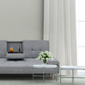 Grey fabric sofa bed with fold-down cup holder tray open holding drinks and water bottle in living room