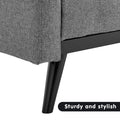Close-up of grey fabric sofa bed lower frame and black tapered leg with Sturdy and stylish text label