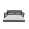 Grey fabric sofa bed fully extended showing white mattress, two scatter pillows and wood frame base with casters