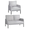 Grey fabric sofa set angle view: armchair above two-seater loveseat, both with black metal legs, on white background