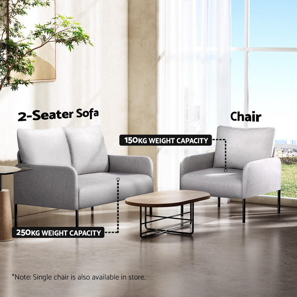 Light grey 2-seater sofa and matching chair in living room, 250kg and 150kg capacity labels, oval coffee table and window